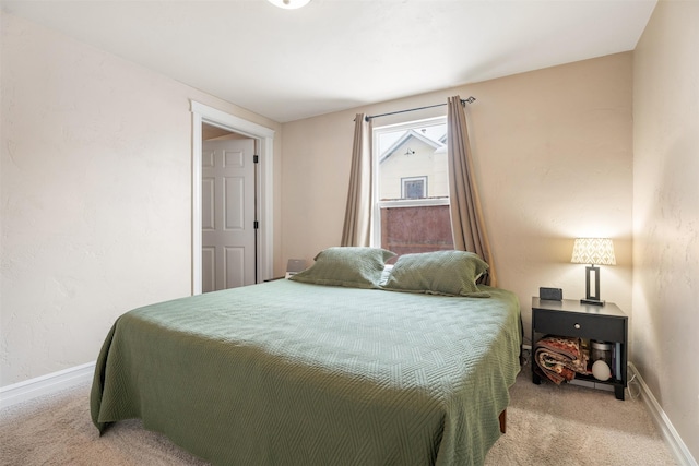 bedroom featuring carpet and baseboards