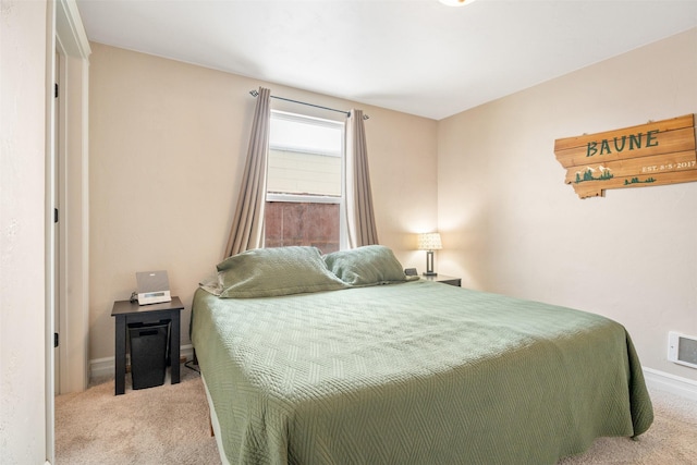 bedroom with light carpet and baseboards