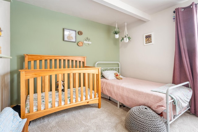 bedroom featuring carpet flooring and beam ceiling