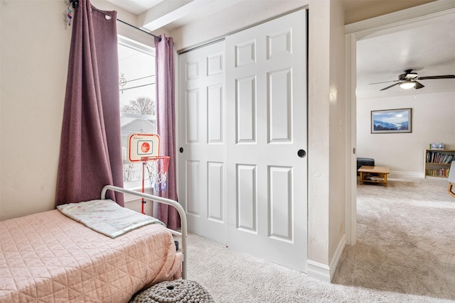 bedroom with a closet, baseboards, and carpet flooring