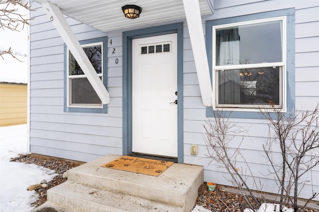 view of snow covered property entrance