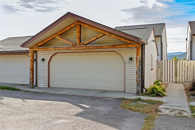 garage with fence and a mountain view