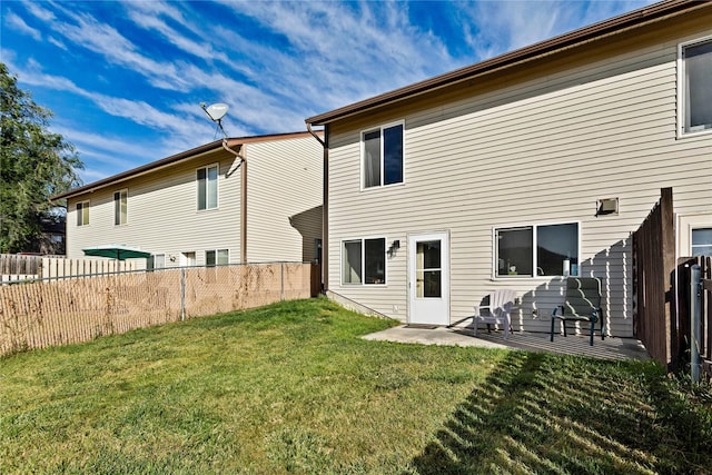 back of house featuring fence, a patio, and a yard