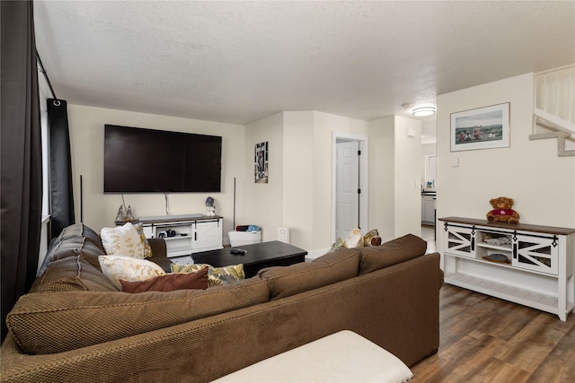 living area with dark wood-style floors and a textured ceiling