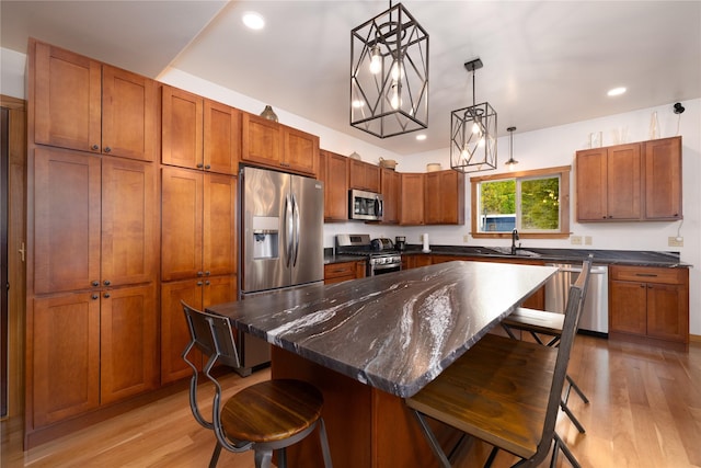 56 Nelson Dr, Rexford, MT 59930 - kitchen featuring a breakfast bar area, hanging light fixtures, appliances with stainless steel finishes, a sink, and a kitchen island