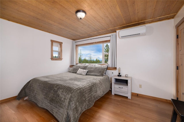 56 Nelson Dr, Rexford, MT 59930 - bedroom with wooden ceiling, a wall mounted air conditioner, baseboards, and light wood finished floors