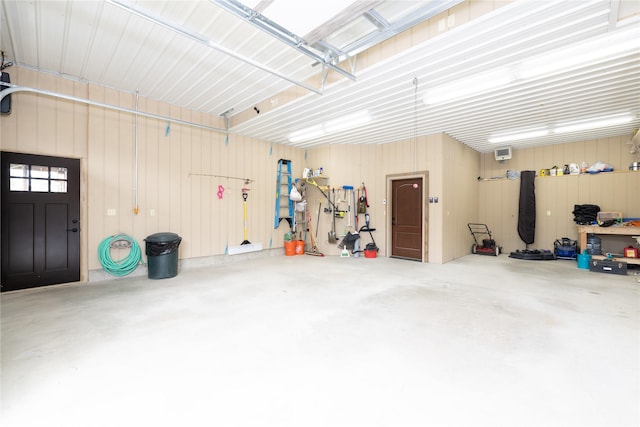 56 Nelson Dr, Rexford, MT 59930 - garage featuring a workshop area, metal wall, and a wall mounted air conditioner