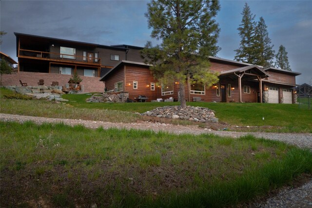 56 Nelson Dr, Rexford, MT 59930 - view of front facade featuring an attached garage and a front lawn