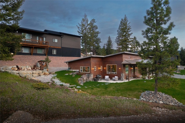 56 Nelson Dr, Rexford, MT 59930 - rear view of property featuring a patio and a yard