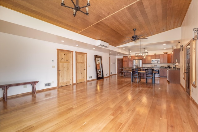 56 Nelson Dr, Rexford, MT 59930 - interior space featuring lofted ceiling, wooden ceiling, a wall unit AC, visible vents, and light wood finished floors