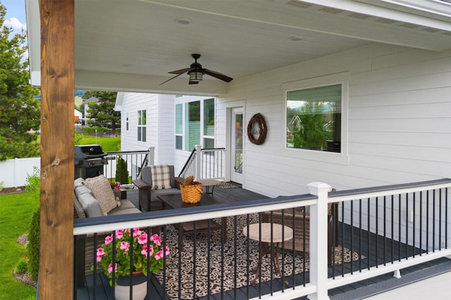 deck with fence, a ceiling fan, and a grill