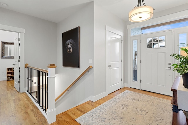 entryway featuring light wood-style flooring and baseboards