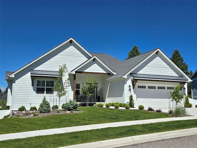 view of front facade with a front lawn, a standing seam roof, metal roof, and an attached garage