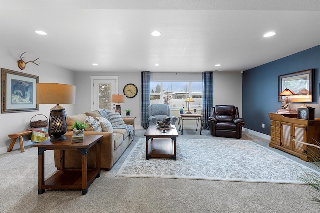 carpeted living area featuring recessed lighting and baseboards