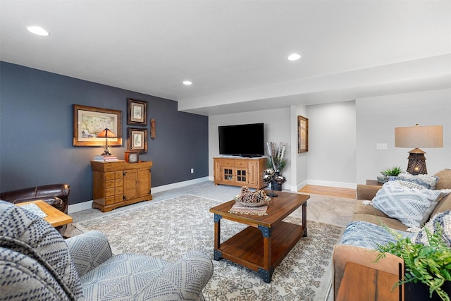 living area with baseboards and recessed lighting