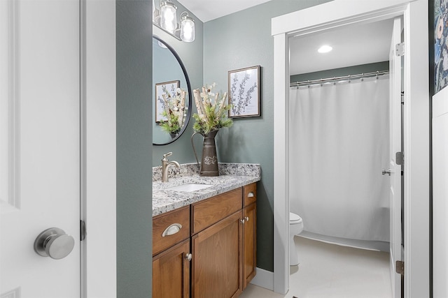 bathroom featuring curtained shower, vanity, and toilet