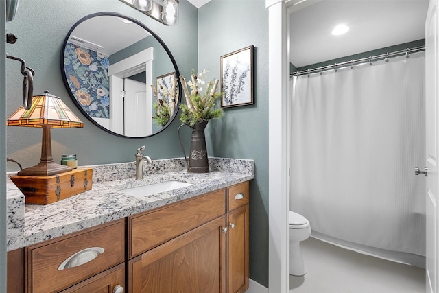 full bath featuring toilet and vanity