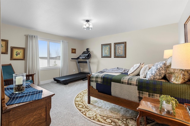 bedroom featuring baseboards and light colored carpet