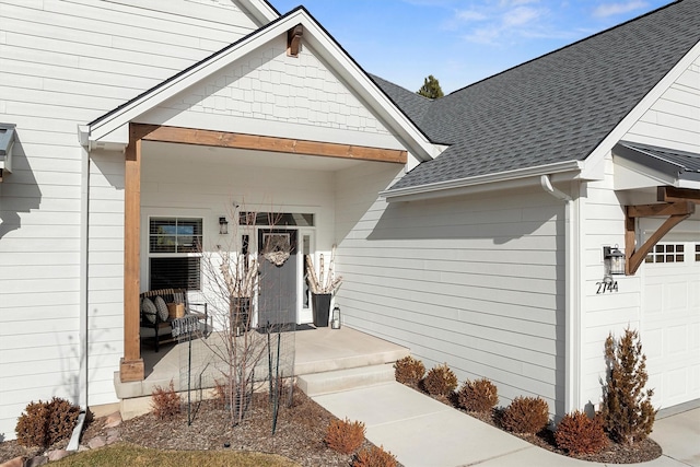 entrance to property with an attached garage, a porch, and a shingled roof