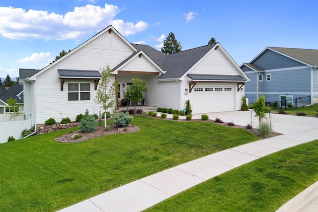 view of front of house with driveway, a standing seam roof, a front yard, and fence