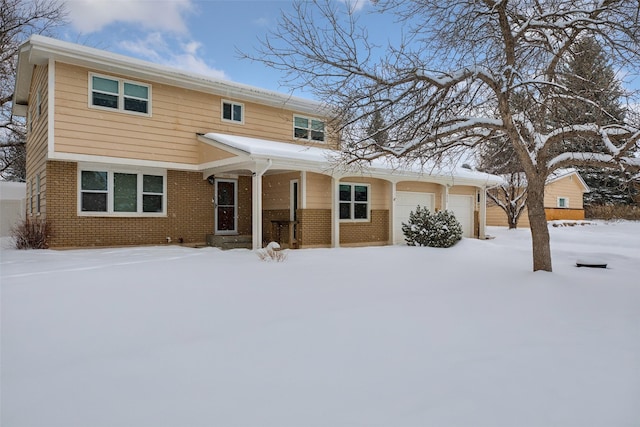 traditional-style home featuring brick siding and an attached garage