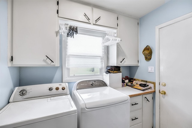 laundry room featuring cabinet space and washer and clothes dryer