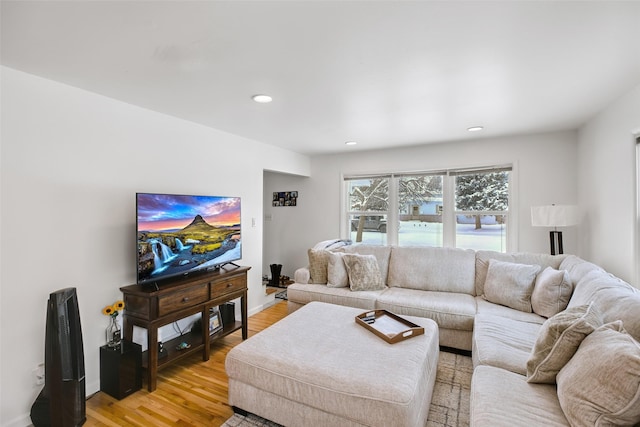 living area with light wood-type flooring, baseboards, and recessed lighting