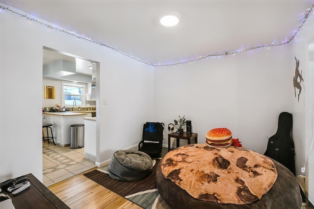 bedroom featuring a sink and light wood-style flooring