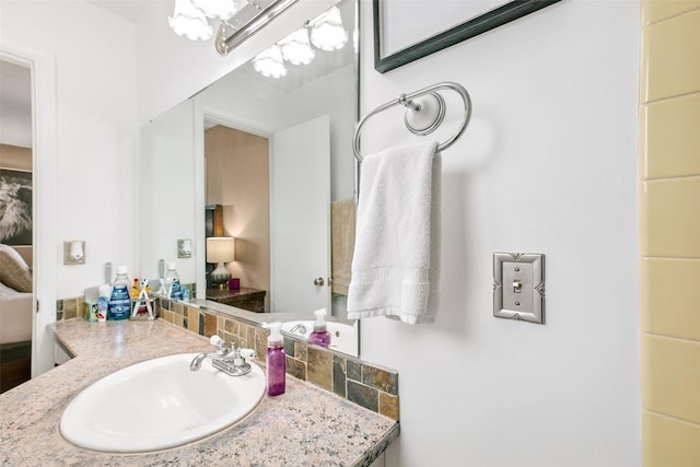 bathroom with an inviting chandelier and vanity