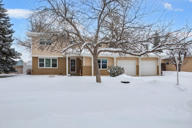 view of front of house featuring a garage and brick siding