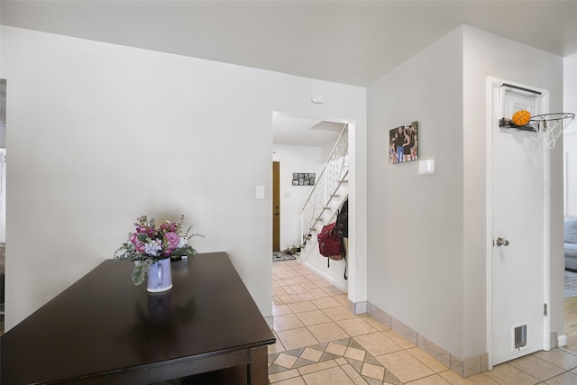 hall with visible vents, stairway, baseboards, and light tile patterned floors