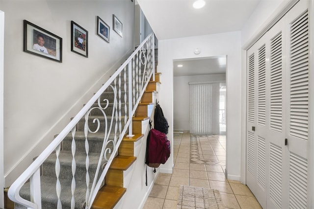 stairway featuring recessed lighting, tile patterned flooring, and baseboards