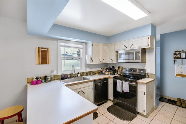 kitchen with electric range oven, light countertops, stainless steel microwave, and a sink