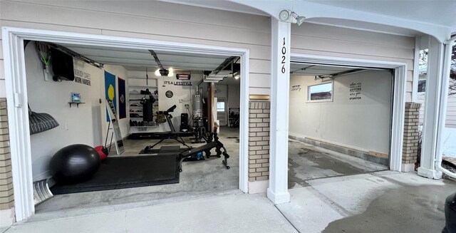 garage featuring gas water heater and a garage door opener