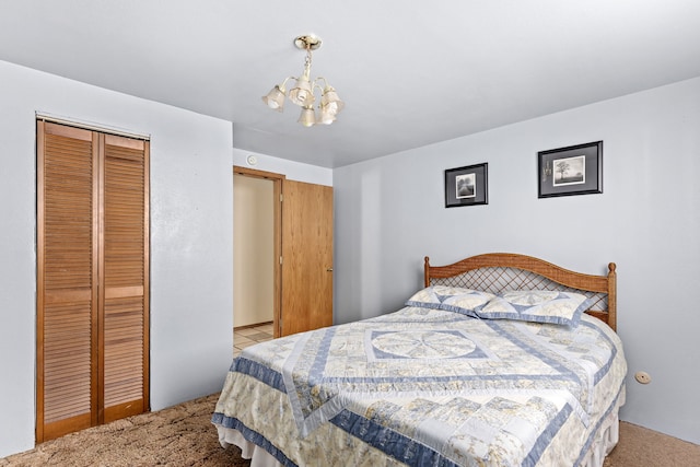 bedroom with light carpet, a notable chandelier, and a closet