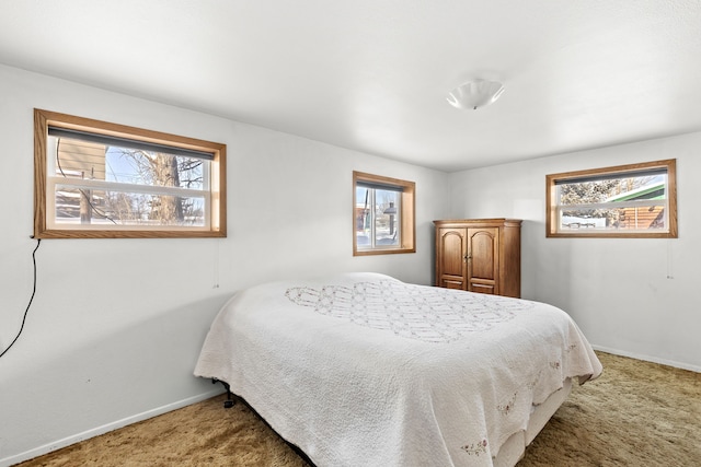 carpeted bedroom featuring baseboards