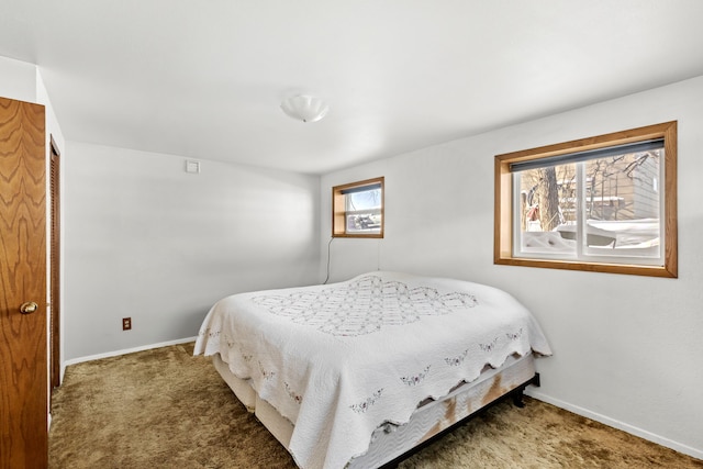 carpeted bedroom featuring baseboards