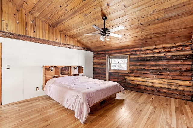 bedroom featuring light wood finished floors, rustic walls, a ceiling fan, wood ceiling, and vaulted ceiling