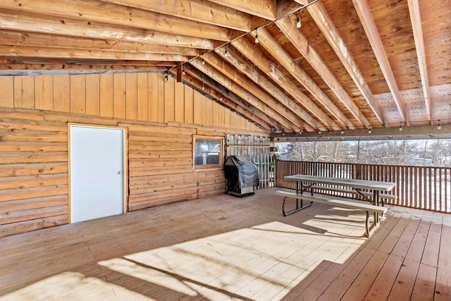 wooden terrace with outdoor dining area and area for grilling