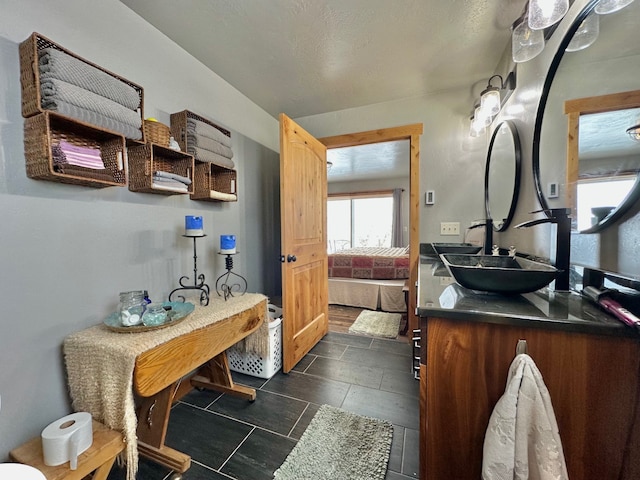 bathroom with connected bathroom and vanity