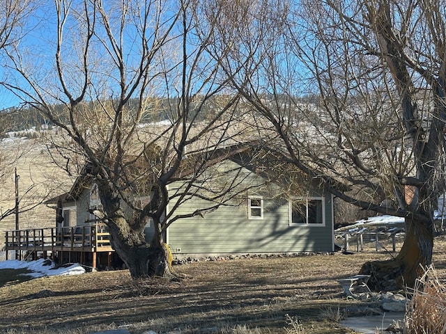 view of property exterior featuring a wooden deck