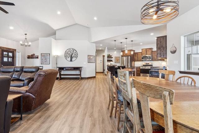 dining space featuring lofted ceiling, light wood-style flooring, baseboards, and recessed lighting