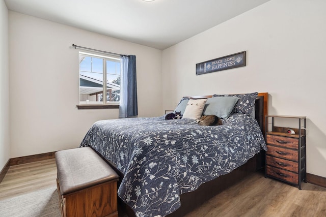 bedroom featuring wood finished floors and baseboards