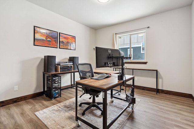 home office with light wood finished floors and baseboards