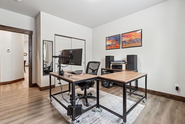 home office featuring light wood-style floors and baseboards