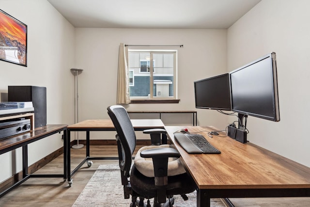 office space with light wood-style flooring and baseboards