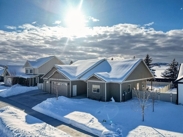 view of front of home featuring driveway, board and batten siding, and an attached garage