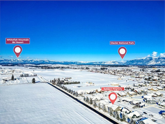 snowy aerial view featuring a mountain view