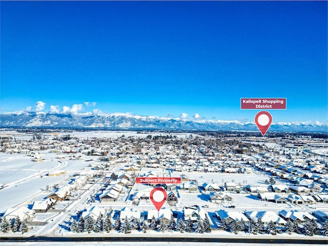 snowy aerial view with a mountain view