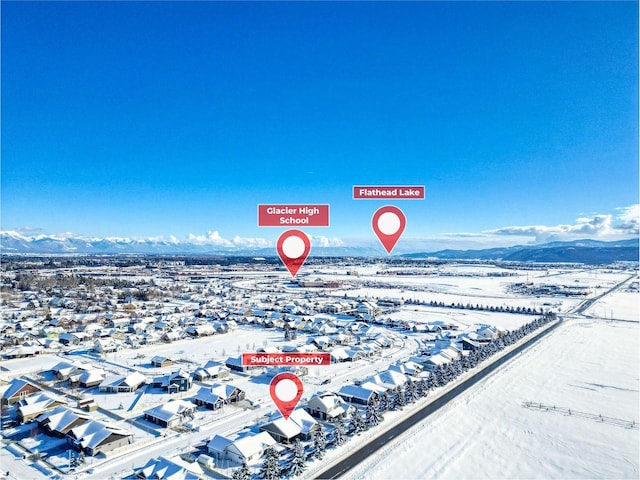 snowy aerial view featuring a mountain view